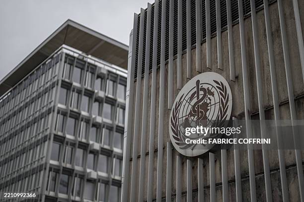 This photograph shows a logo of the World Health Organisation displayed on the facade of organisation's headquarters in Geneva on April 23, 2025. The...