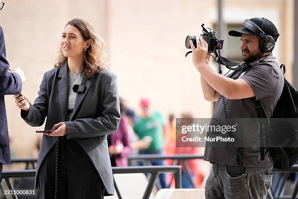 Journalist and a camera operator are seen filming an interview at the Vatican in Rome on April 23, 2025.