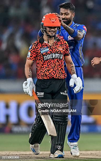 Mumbai Indians' captain Hardik Pandya gestures as Sunrisers Hyderabad's Ishan Kishan walks back to the pavilion after his dismissal during the Indian...
