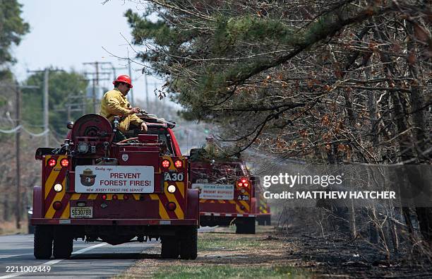 New Jersey Forest Fire Service fire crews work to extinguish the Jones Road Fire near Lacey Township in Ocean County, New Jersey, on April 23, 2025....