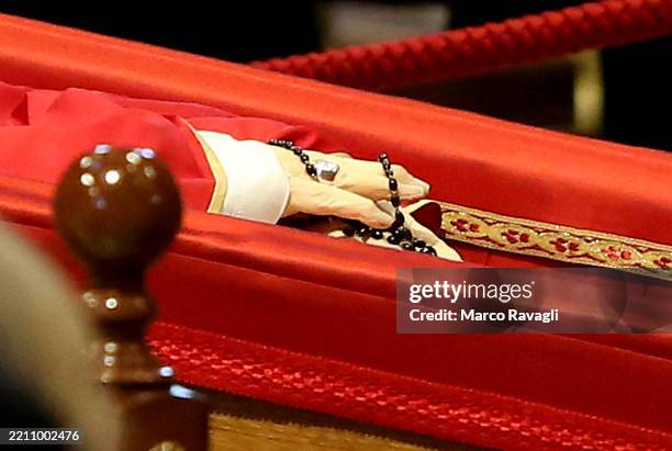 People walk past the coffin as they pay their respects to the late Pope Francis as his body lies in state at St. Peter's Basilica in the Vatican....