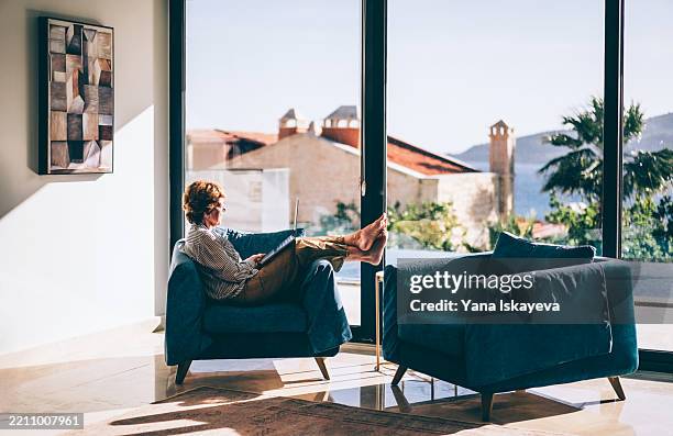modern senior lifestyle in a sunlit coastal retreat - high society stock pictures, royalty-free photos & images