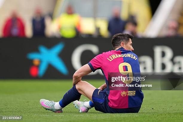 Robert Lewandowski of FC Barcelona goes down with an injury during the La Liga match between FC Barcelona and RC Celta de Vigo at Estadi Olimpic...