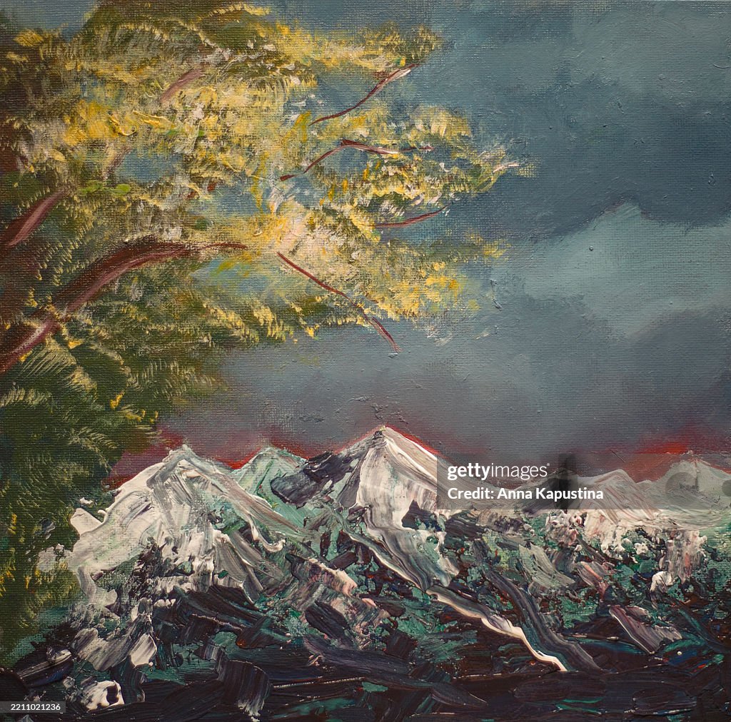 Snow-capped mountains against the background of a flowering tree