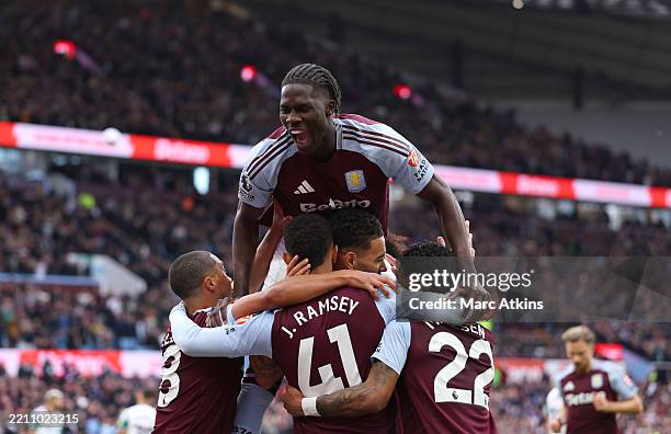 Amadou Onana of Aston Villa celebrates his team's third goal with teammates, an own-goal scored by Dan Burn of Newcastle United during the Premier...