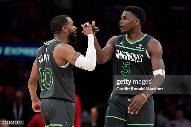 Mike Conley and Anthony Edwards of the Minnesota Timberwolves react after a play against the Los Angeles Lakers during the third quarter in Game One...