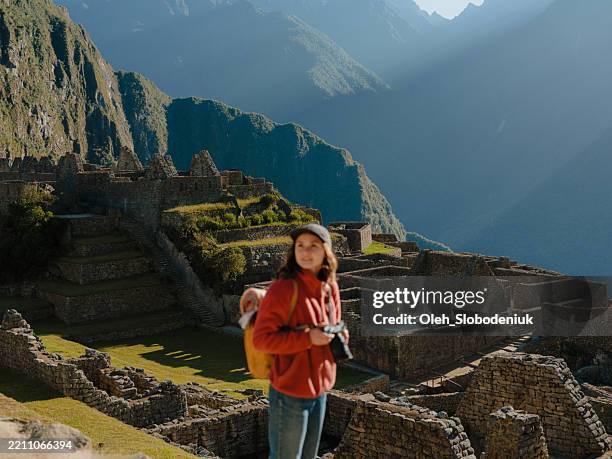 woman looking at scenic view of machu picchu in peru - hiking machu picchu stock pictures, royalty-free photos & images