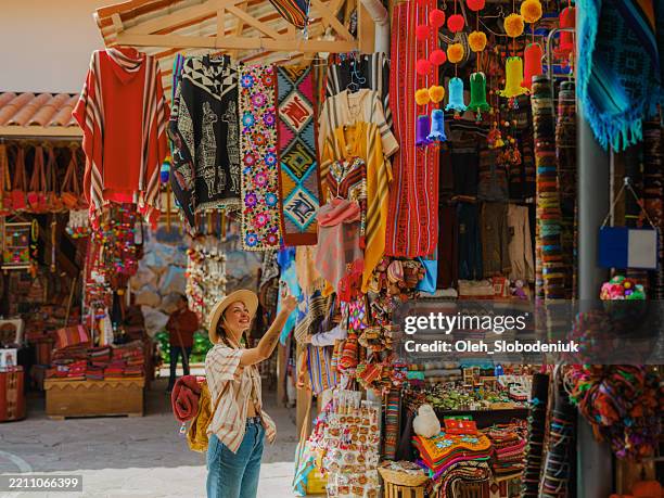 woman photographing with smartphone on pisac market in peru - sydamerika bildbanksfoton och bilder