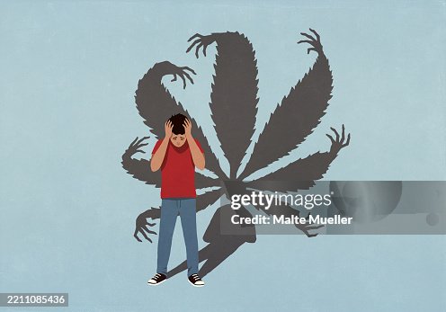 Cannabis leaf shadow with hands looming behind overwhelmed young man with head in hands Cannabis leaf shadow with hands looming behind overwhelmed young man with head in hands