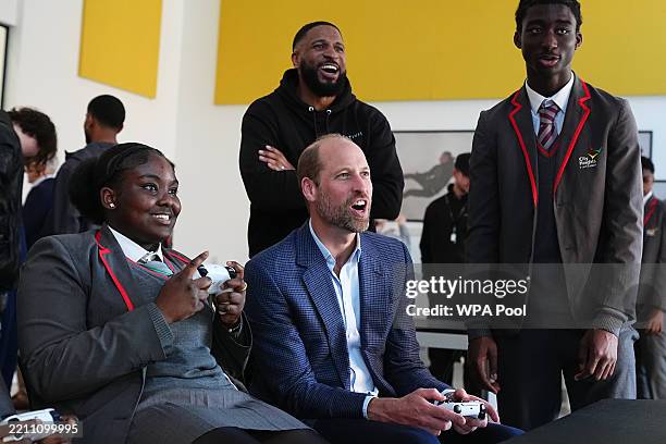 Prince William, Prince of Wales plays a computer game during a visit to the Mentivity community centre and youth hub in Southwark, South London on...