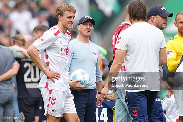 Gerhard Struber, Head Coach of 1. FC Köln, looks at Timo Huebers as they celebrate at full-time following the team's victory in the Second Bundesliga...