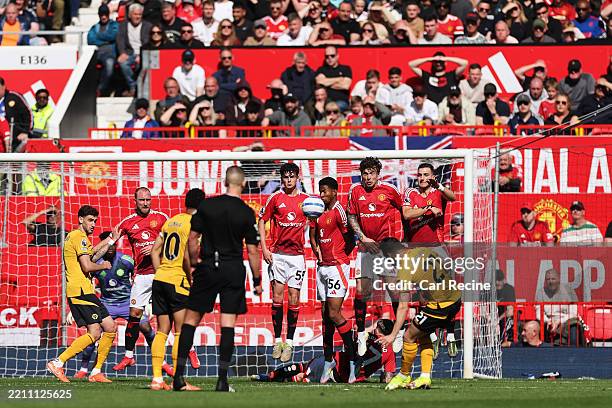Tyler Fredricson, Chido Obi-Martin, Victor Lindeloef and Diogo Dalot of Manchester United fail to make a block as Pablo Sarabia of Wolverhampton...