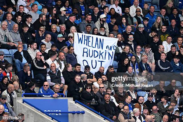 Fans of Leicester City display a banner in protest of the teams board which reads "Whelan and Rudkin out" during the Premier League match between...