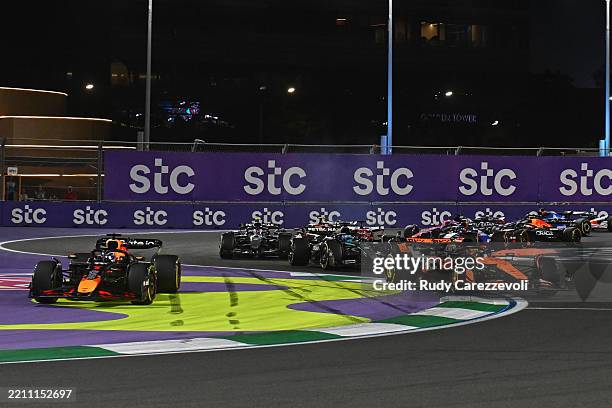 Max Verstappen of the Netherlands driving the Oracle Red Bull Racing RB21 runs wide as Oscar Piastri of Australia driving the McLaren MCL39 Mercedes...