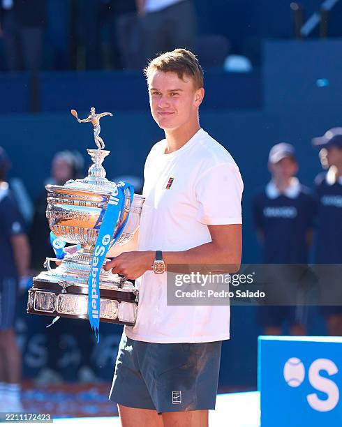 Holger Rune of Denmark poses with the winners trophy after defeating Carlos Alcaraz of Spain in the Men's Singles Final Match during Day Seven of the...