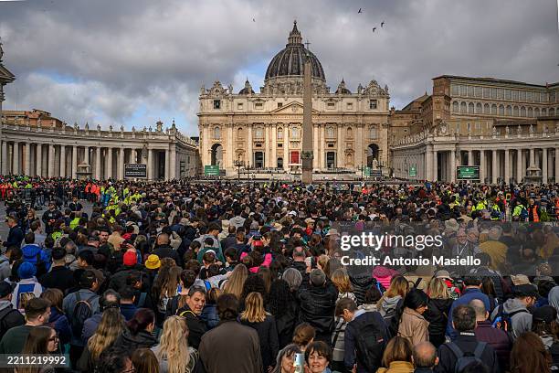 Faithful join a long line outside St Peter's Square to view the body of Pope Francis laying in state inside St Peter's Basilica, on April 25, 2025 in...