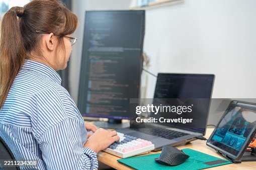 Software Developer Debugging Code in a Modern Tech Office. Software Developer Debugging Code in a Modern Tech Office.