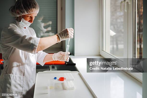 lab technician doctor working with sperm samples using pipette in laboratory - fertility lab stock pictures, royalty-free photos & images