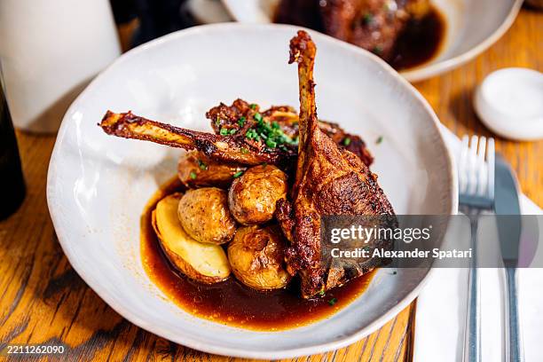 lamb chops served with baby potatoes at a french restaurant, paris, france - french food stock pictures, royalty-free photos & images
