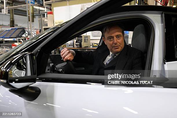 Belgium's Prime Minister Bart de Wever sits in a Volvo X30 electric car during a visit of the extension of the Volvo factory, which will produce this...