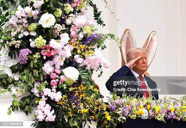 President Donald Trump salutes during the national anthem as he delivers remarks during the White House Egg Roll on the South Lawn on April 21, 2025...