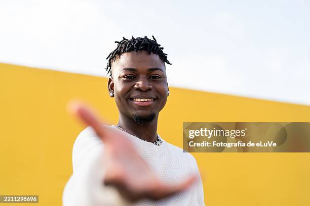 young man extending hand for handshake, greeting or reaching out - sayings stock pictures, royalty-free photos & images
