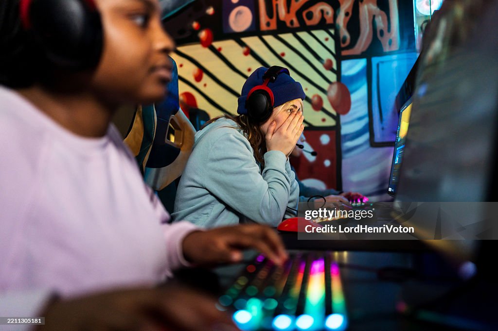 Frustrated gamer covering face while playing videogames