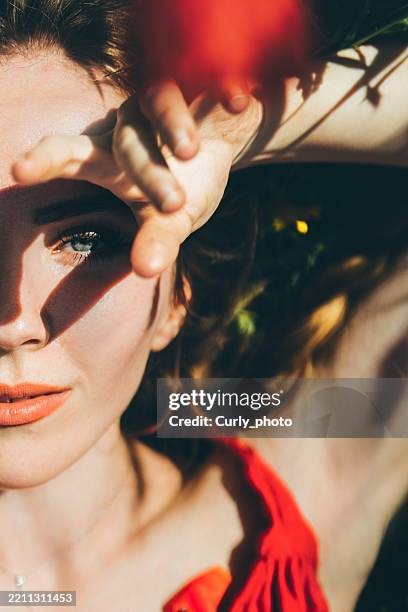 dreamy portrait of a young woman in flower field. - vida sencilla fotografías e imágenes de stock