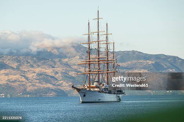 windjammer sailing near saranda, albania with corfu island in the background - tall ship stock pictures, royalty-free photos & images