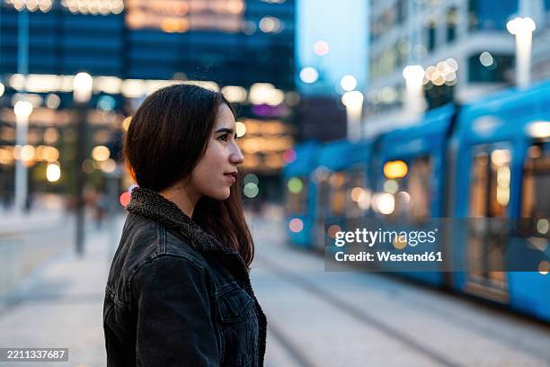 young woman commuting by tram in birmingham city - birmingham city england stock pictures, royalty-free photos & images