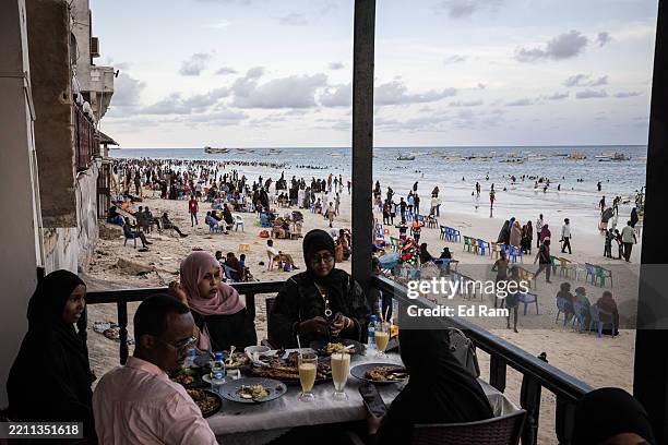 Dinners sit in a restaurant as people swim and spend time on Mogadishu's Lido beach, on April 25, 2025 in Mogadishu, Somalia. There are concerns of a...