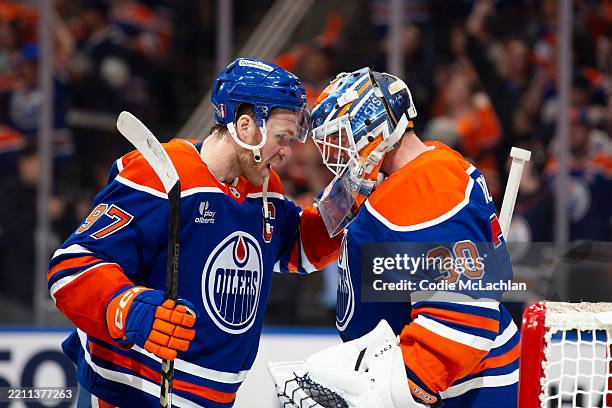 Connor McDavid and goaltender Calvin Pickard of the Edmonton Oilers celebrate their victory against the Los Angeles Kings during the third period in...