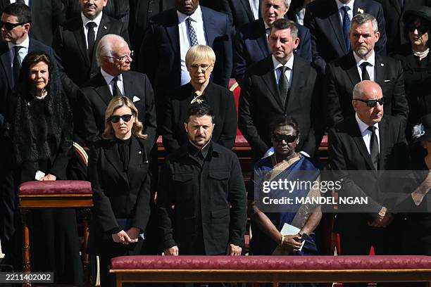 Ukraine's President Volodymyr Zelensky and his wife Olena Zelenska stand alongside other leaders including India's President Droupadi Murmu and...