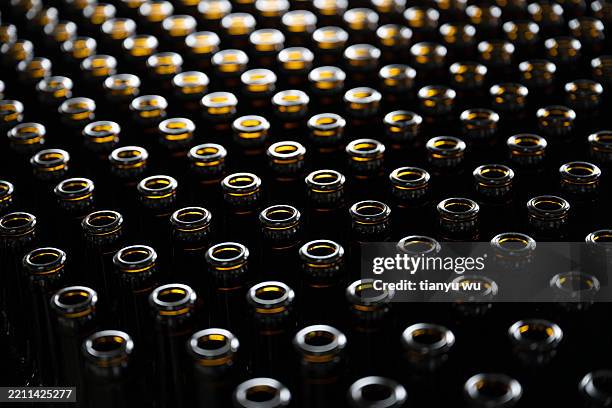 close up of glass beer bottles in production - beer filling stock pictures, royalty-free photos & images