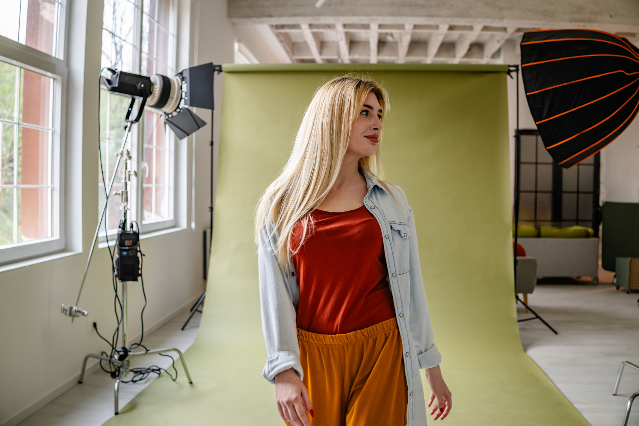 Young blonde woman showcases modern fashion in a vibrant studio setting with professional lighting Young blonde woman showcases modern fashion in a vibrant studio setting with professional lighting