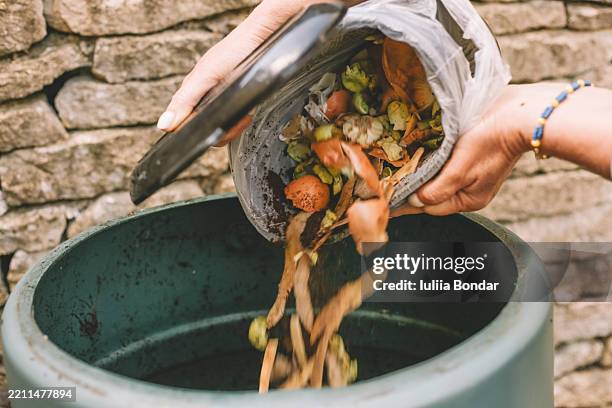 emptying kitchen waste into compost bin - food compost stock pictures, royalty-free photos & images