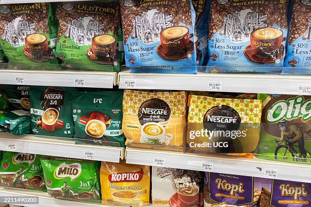 Supermarket shelf stocked with various brands of instant coffee, including Nescafe and Old Town White Coffee. Soft packs, Kuala Lumpur Malaysia,.