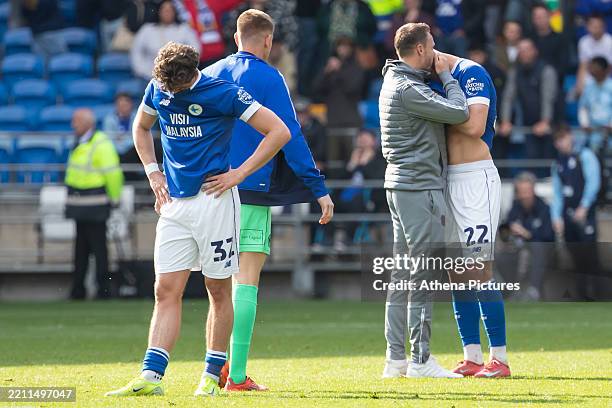 Ollie Tanner and Yousef Salech of Cardiff City react at full time as they get relegated to League One during the Sky Bet Championship match between...