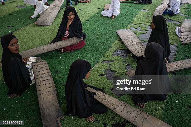 Girls learn verses from the Quran and recite poetry in Arabic, during an evening Sufi religious meeting on April 22, 2025 in Mogadishu, Somalia....