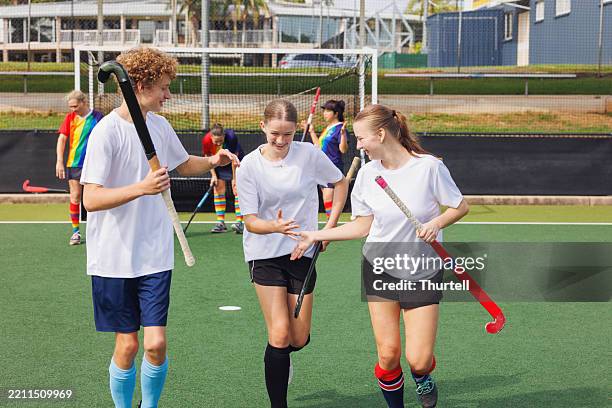 junior hockey players celebrate scoring a goal - field hockey stock pictures, royalty-free photos & images