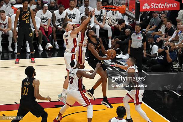 Evan Mobley of the Cleveland Cavaliers drives to the basket during the game against the Miami Heat during Round 1 Game 3 of the 2025 NBA Playoffs on...