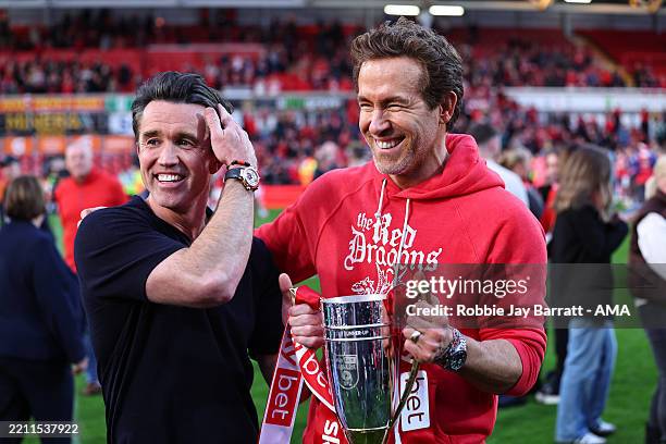 Rob McElhenney and Ryan Reynolds co-owners of Wrexham with the promotion trophy during the Sky Bet League One match between Wrexham AFC and Charlton...