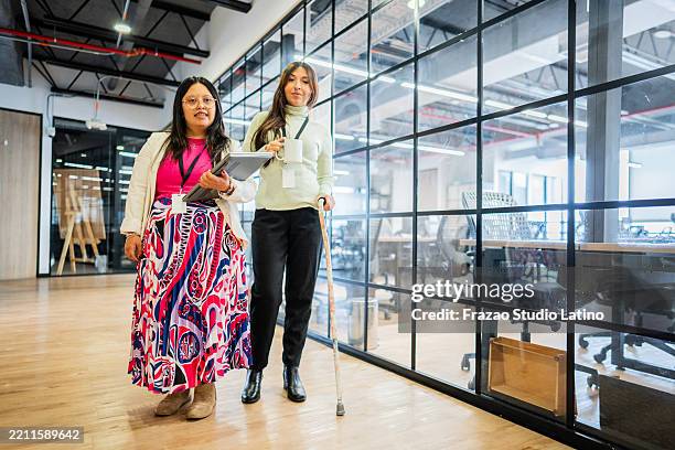 portrait of a coworkers walking on the office - crutch stock pictures, royalty-free photos & images