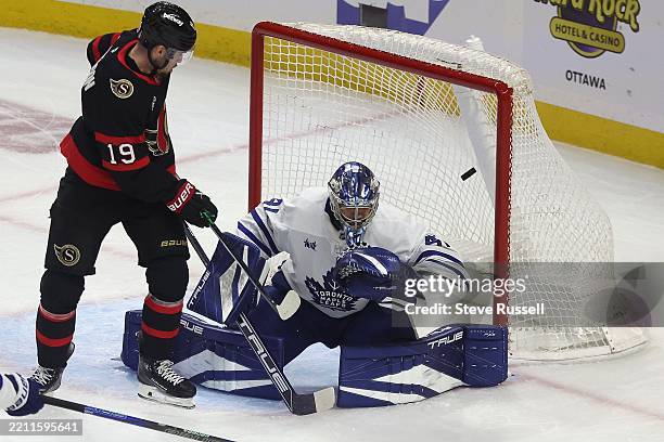 Ottawa Senators right wing Drake Batherson watches as a point shot by Ottawa Senators center Matthew Highmore beats Toronto Maple Leafs goaltender...