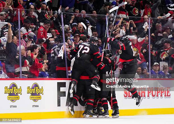Members of the Ottawa Senators celebrate an overtime goal by Jake Sanderson against the Toronto Maple Leafs in Game Four of the First Round of the...