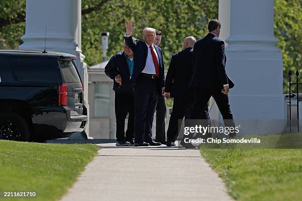 President Donald Trump wavesto reporters after inspecting the North Lawn with members of the White House grounds crew to look for a place to put a...