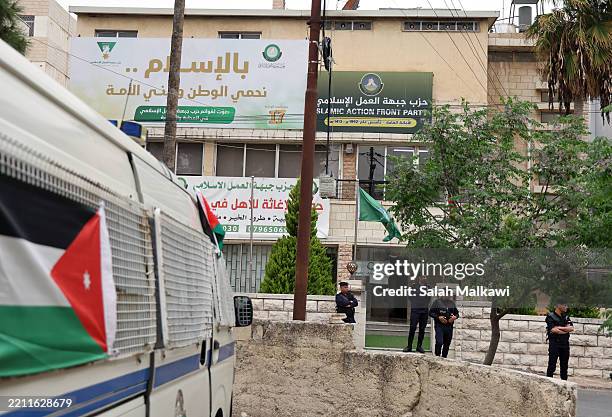 Jordanian police close the entrance of a Muslim Brotherhood headquarter after the announcement of banning the society in the country on April 23,...