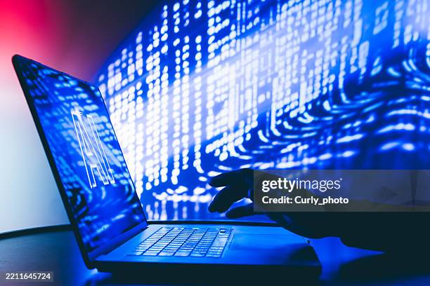 man using laptop with artificial intelligence screen in neon light. - screen replacement stock pictures, royalty-free photos & images