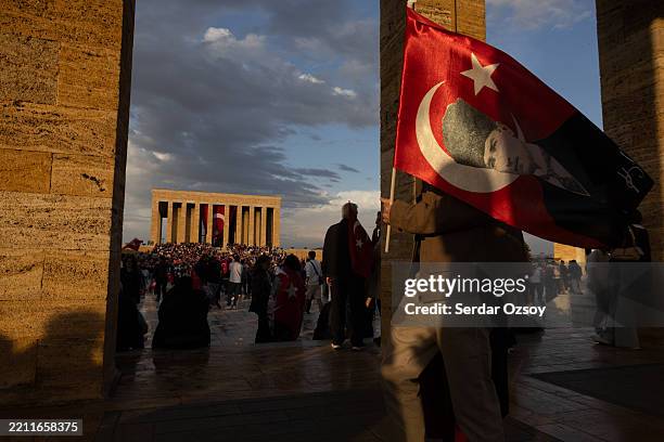 People wave flags and chant slogans during a mass protest rally in support of the arrested Istanbul Mayor Ekrem Imamoglu at Anitkabir, mausoleum of...