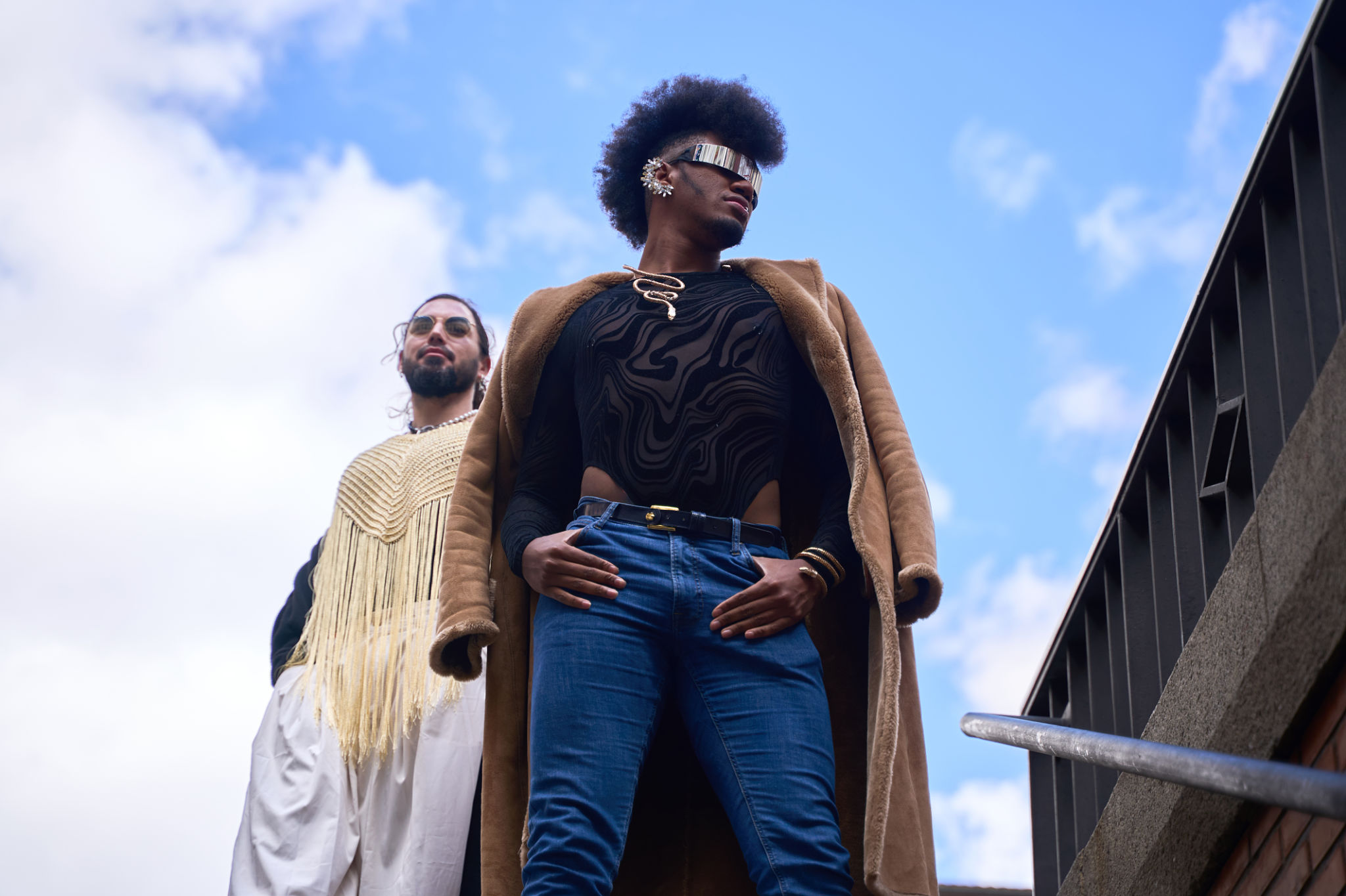 Gay couple posing on urban staircase, embracing diversity and pride Gay couple posing on urban staircase, embracing diversity and pride
